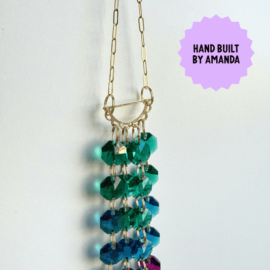 Beaded Suncatcher with green and blue beads on a white background, labeled 'Hand Built by Amanda'.