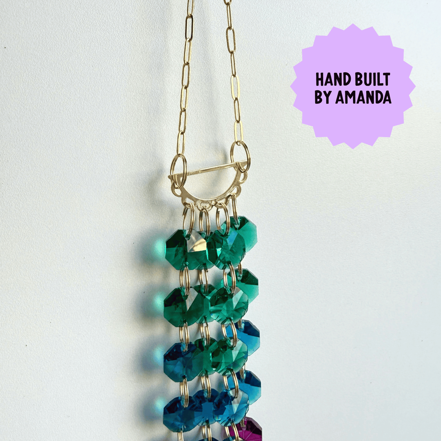 Beaded Suncatcher with green and blue beads on a white background, labeled 'Hand Built by Amanda'.